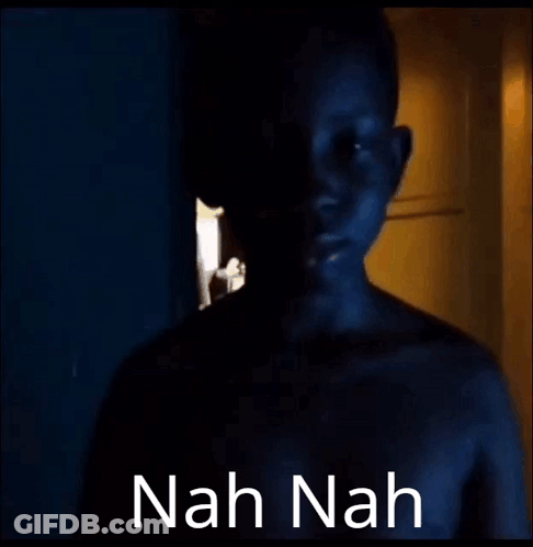 A Naked Man Is Standing In A Dark Room With The Words `` Nah Nah '' Written On The Bottom . GIF