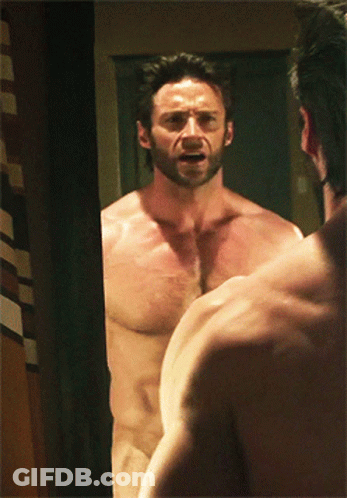 A Naked Man Looks At Himself In The Mirror GIF