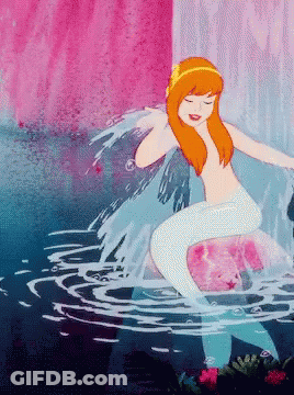 A Naked Mermaid Is Sitting On A Rock In The Water With Her Eyes Closed GIF
