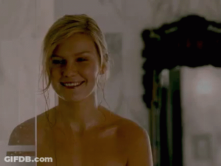 A Naked Woman Is Smiling Behind A Glass Door GIF