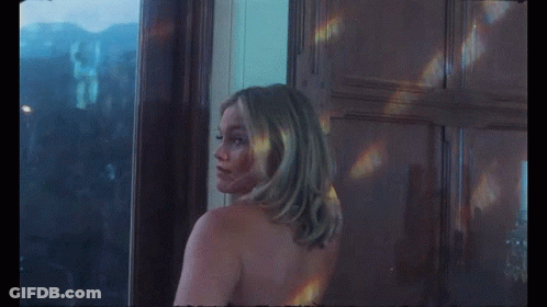 A Naked Woman Is Standing In Front Of A Window GIF