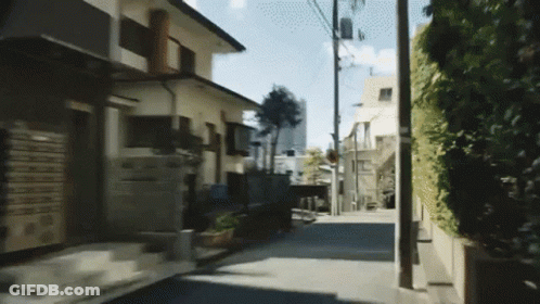 A Narrow Street With A Few Houses On The Side GIF