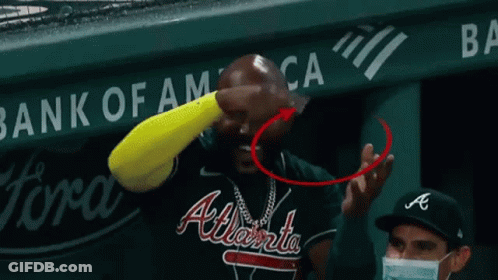 A National Car Rental Sign Is Behind A Baseball Field GIF