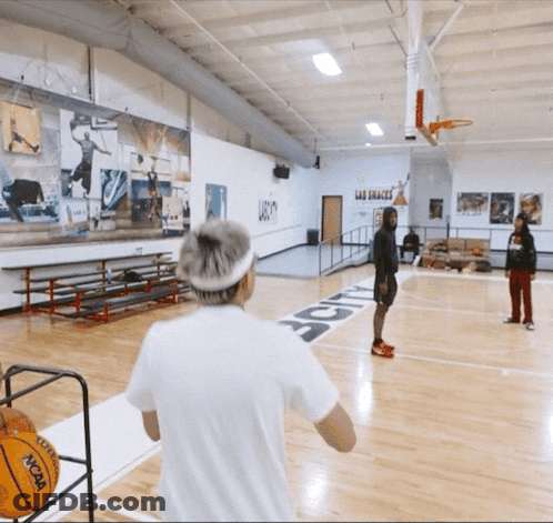 A Ncaa Basketball Is Being Thrown On The Court GIF