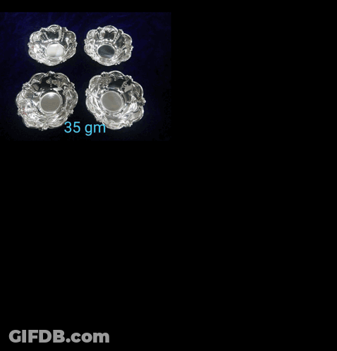 A Necklace And Earrings Are Displayed On A Black Velvet Shelf GIF