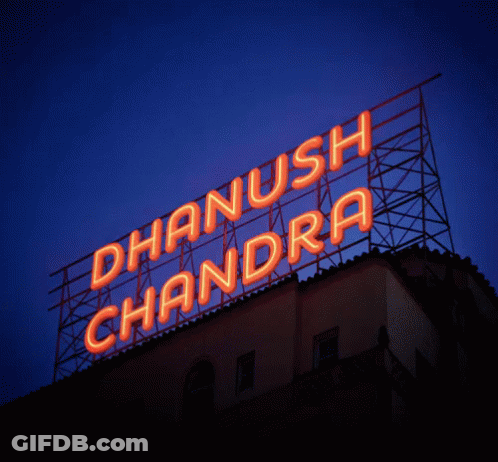 A Neon Sign For Dhanush Chandra Is Lit Up In Orange GIF