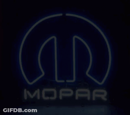 A Neon Sign For Mopar Is Lit Up In The Dark GIF