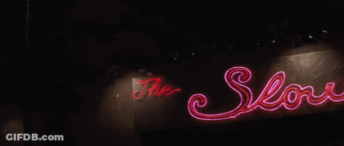 A Neon Sign For The Low Club With A Deer Head On It GIF