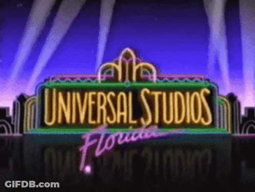 A Neon Sign For Universal Studios Florida With A City In The Background GIF