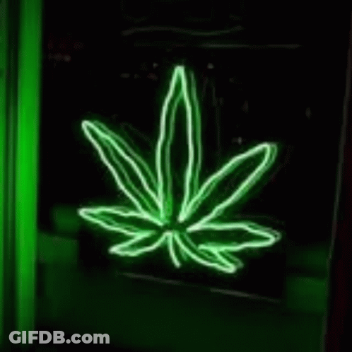 A Neon Sign Of A Hand Crossing Its Fingers In A Green Room . GIF