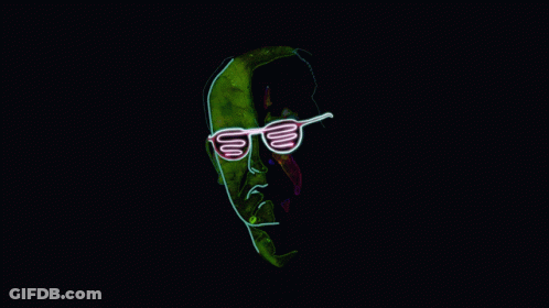 A Neon Sign Of A Man Wearing Sunglasses On A Dark Background GIF