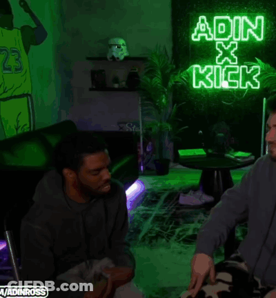 A Neon Sign That Says ' Adin X Kick ' Is Lit Up In A Dark Room GIF