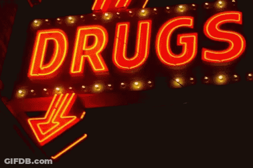 A Neon Sign That Says " Drugs " With An Arrow Pointing To The Right GIF