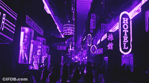A Neon Sign That Says Hotel Is Lit Up At Night GIF