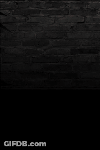 A Neon Sign That Says Stoner On A Black Brick Wall GIF