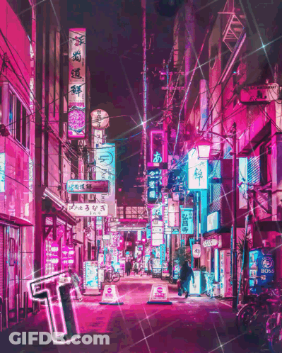 A Neon Sign That Says ' T ' On It Is In The Middle Of A City Street GIF