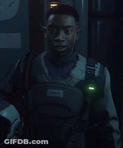 A Neon Sign That Says Wish Him Luck With A Man Behind It GIF