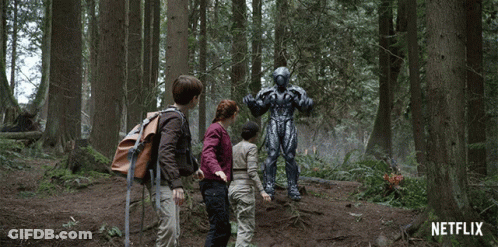 A Netflix Ad Shows A Group Of Children Standing In A Forest GIF