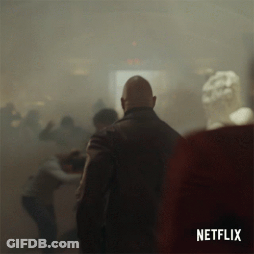 A Netflix Ad Shows A Man In A Crowd Of People GIF