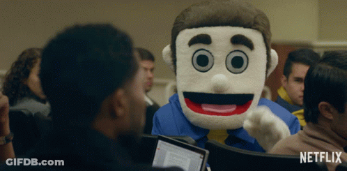A Netflix Ad Shows A Man In A Mascot Costume Talking To A Group Of People GIF