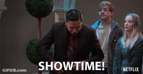 A Netflix Ad Shows A Man In A Suit And Tie Standing Next To A Woman GIF