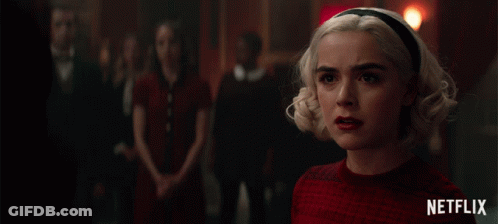 A Netflix Ad Shows A Woman In A Red Sweater GIF