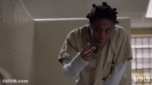 A Netflix Ad Shows A Woman In An Orange Uniform GIF