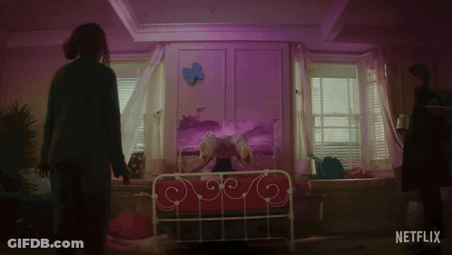 A Netflix Ad Shows A Woman Standing In Front Of A Girl On A Bed GIF