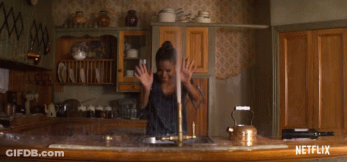 A Netflix Ad Shows A Woman Washing Dishes In A Kitchen GIF