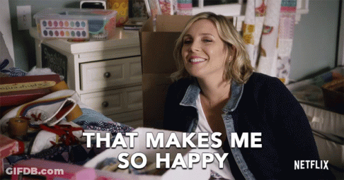 A Netflix Advertisement Shows A Woman Sitting On A Bed Smiling And Saying That Makes Me So Happy GIF