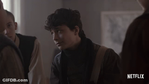 A Netflix Advertisement Shows A Young Man Looking At Something GIF