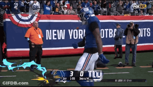 A New York Giants Football Player Runs On The Field GIF