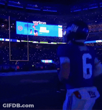 A New York Giants Football Player Stands In Front Of The Metlife Stadium GIF