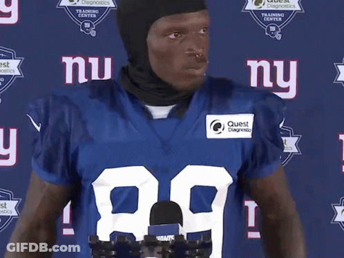 A New York Giants Football Player Wearing A Black Helmet GIF