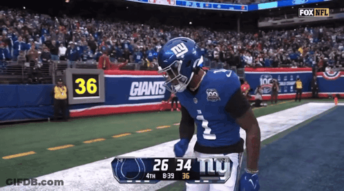 A New York Giants Player Celebrates A Touchdown During A Game GIF