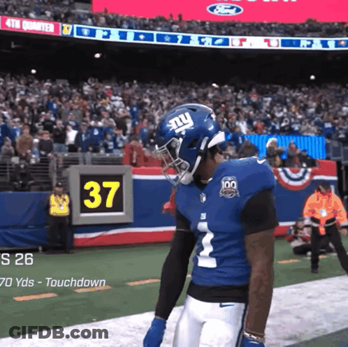 A New York Giants Player Stands On The Field GIF