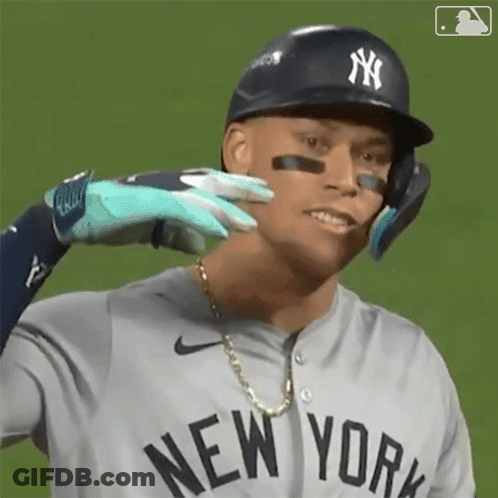 A New York Yankees Baseball Player Is Being Touched By Another Player 'S Glove . GIF