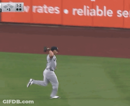 A New York Yankees Baseball Player Is Running Towards A Base GIF