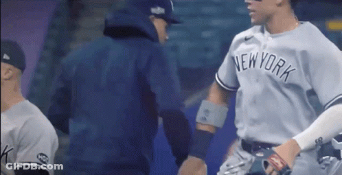 A New York Yankees Baseball Player Shakes Hands With A Coach GIF