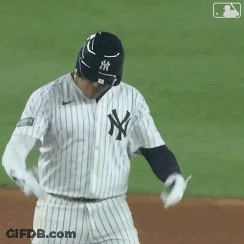 A New York Yankees Baseball Player Wearing A Black And White Striped Jersey GIF