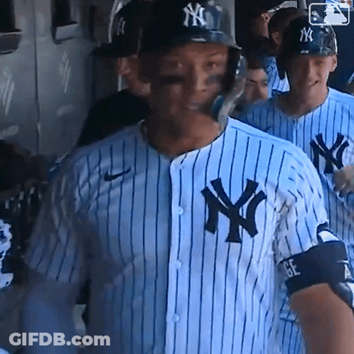 A New York Yankees Baseball Player Wearing A Blue And White Striped Shirt GIF