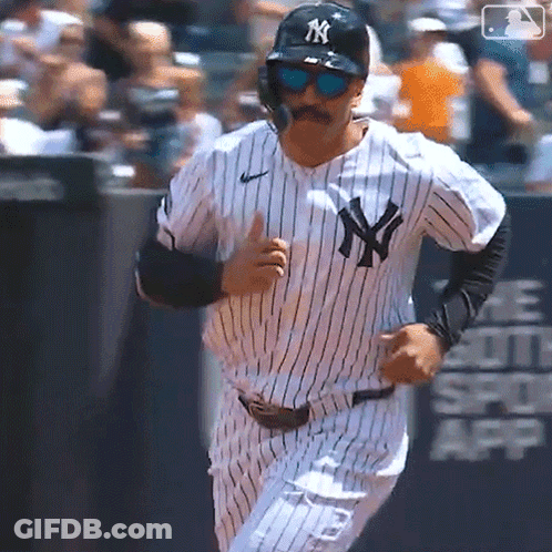 A New York Yankees Baseball Player Wearing Sunglasses And A Mustache Is Running On The Field GIF