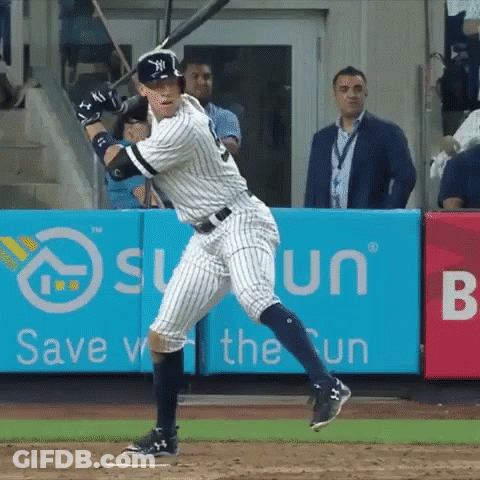 A New York Yankees Player Swings His Bat At A Pitch GIF
