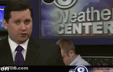 A News Anchor Stands In Front Of The Weather Center GIF