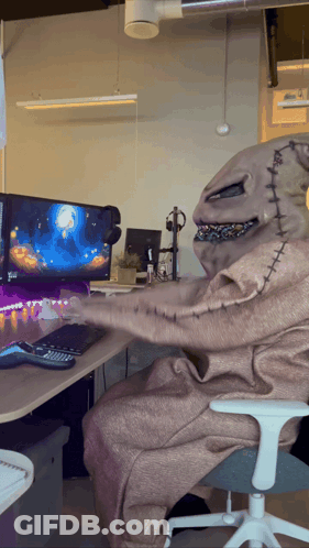A Nightmare Before Christmas Character Is Sitting In Front Of A Computer Screen GIF