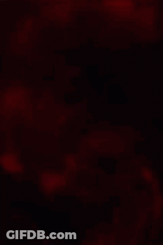 A Ninja Is Holding A Sword In Front Of A Red Snake . GIF