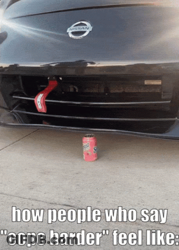 A Nissan Car With A Can Of Gatorade On The Ground Under The Bumper GIF