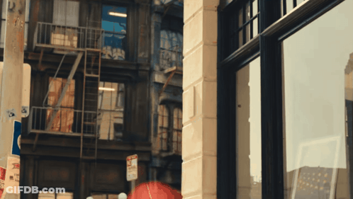 A No Parking Sign Is On The Side Of A Brick Building GIF