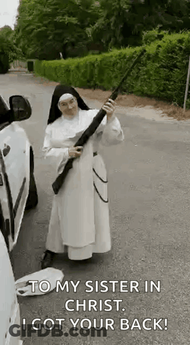 A Nun Is Holding A Gun In Front Of A Car And Says `` To My Sister In Christ , I Got Your Back ! '' GIF