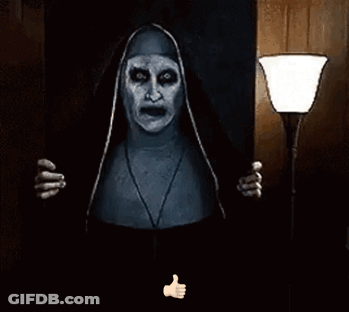 A Nun With Glowing Eyes Is Giving A Thumbs Up Sign . GIF